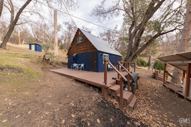 exterior space featuring a deck and a storage unit