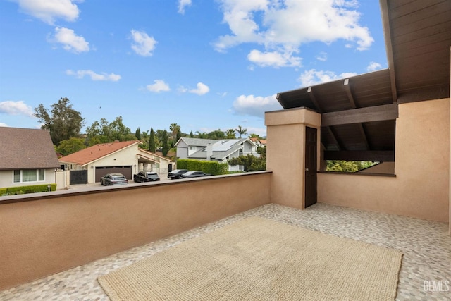 view of patio featuring a balcony and a residential view