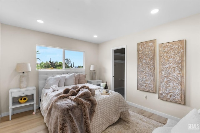 bedroom featuring recessed lighting, light wood finished floors, and baseboards