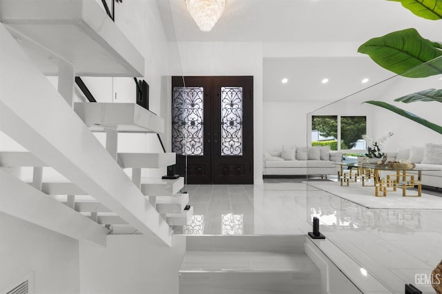 foyer featuring recessed lighting, visible vents, stairway, and french doors