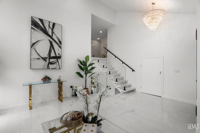 entryway with stairway, a chandelier, and baseboards