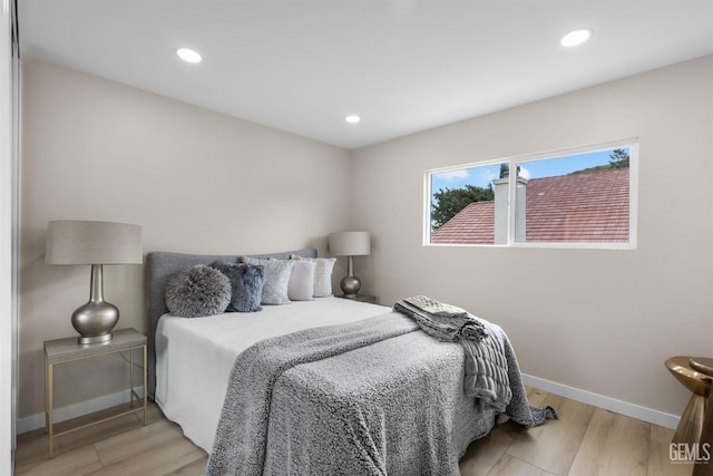 bedroom featuring recessed lighting, wood finished floors, and baseboards