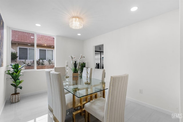 dining room featuring baseboards, recessed lighting, and a notable chandelier