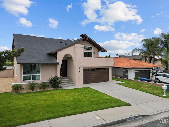 view of front of house with an attached garage, concrete driveway, a front lawn, and stucco siding