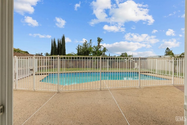 view of swimming pool featuring a fenced backyard, a fenced in pool, and a patio area