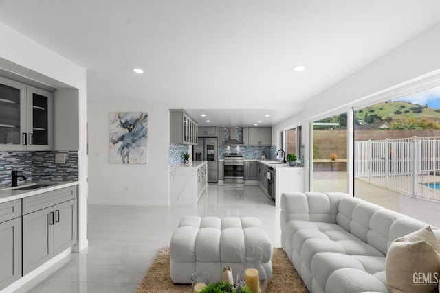 living room with baseboards and recessed lighting