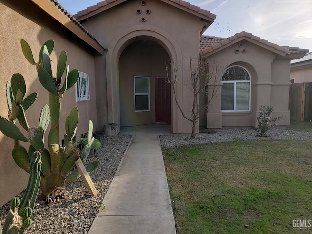 property entrance with a yard