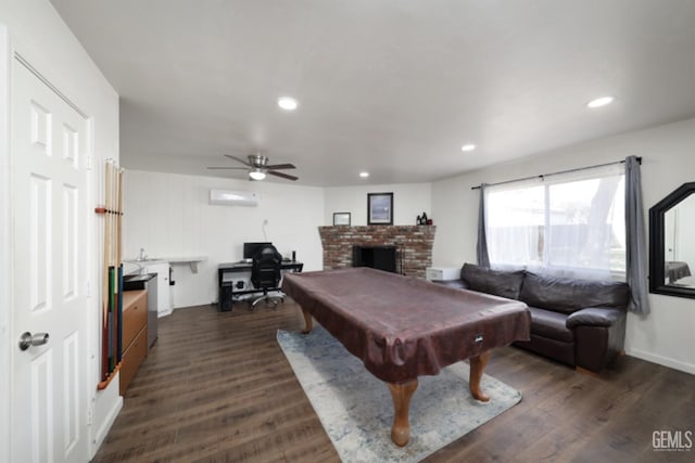 playroom featuring billiards, a wall unit AC, recessed lighting, a fireplace, and dark wood-style flooring