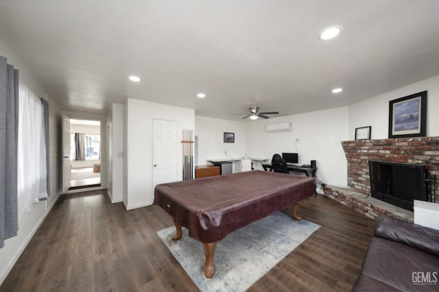 rec room featuring pool table, a brick fireplace, dark wood-type flooring, recessed lighting, and a wall mounted AC