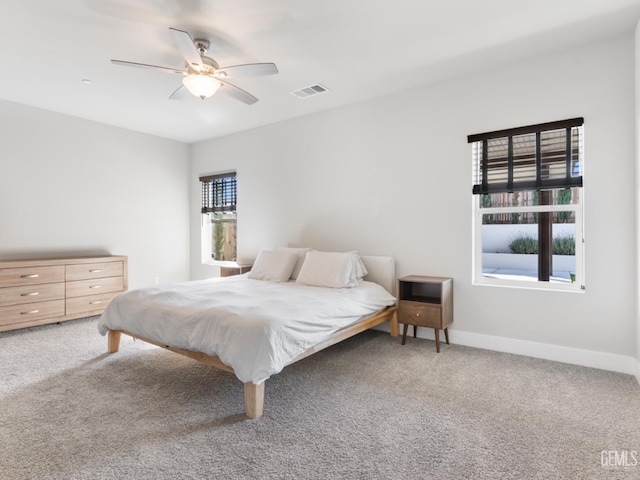 bedroom with carpet, visible vents, ceiling fan, and baseboards