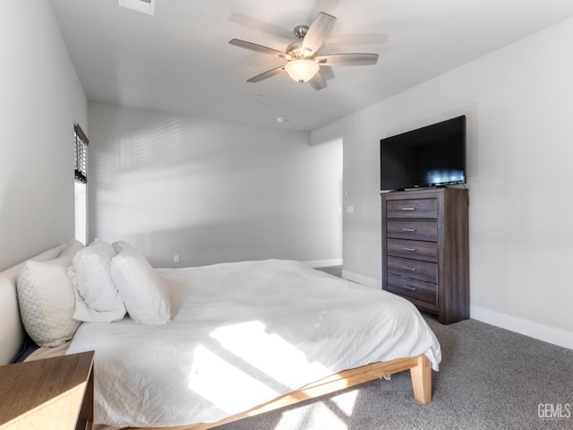 carpeted bedroom featuring ceiling fan and baseboards