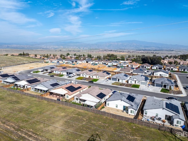 drone / aerial view featuring a residential view and a mountain view