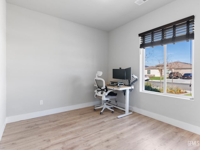 home office featuring light wood finished floors and baseboards