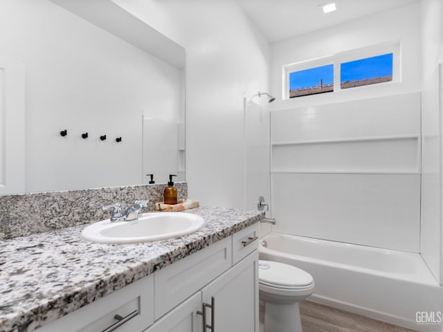 full bathroom featuring toilet, shower / tub combination, wood finished floors, and vanity