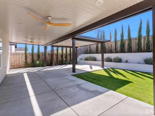 view of patio with a fenced backyard and a ceiling fan