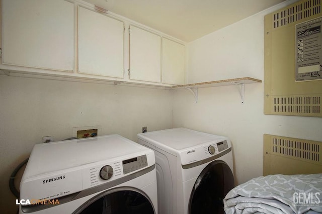 washroom with cabinets and independent washer and dryer