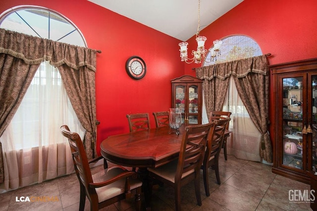 dining area featuring high vaulted ceiling, tile patterned flooring, and a chandelier