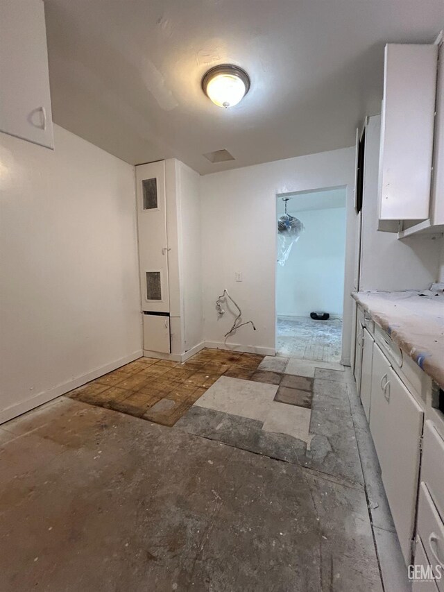 905 Hacienda Dr, Bakersfield, CA 93307 - kitchen featuring white cabinetry and baseboards