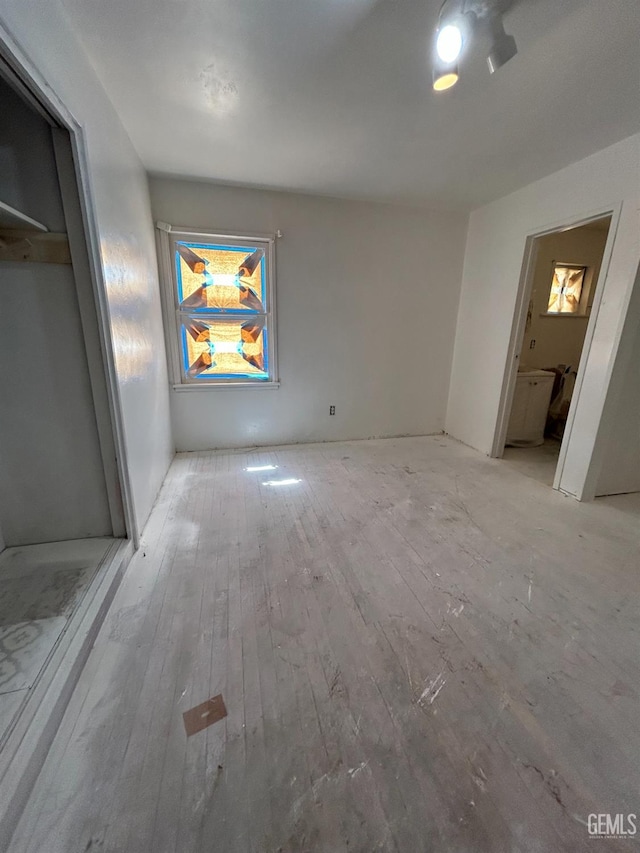 905 Hacienda Dr, Bakersfield, CA 93307 - unfurnished bedroom with wood-type flooring, connected bathroom, and a closet