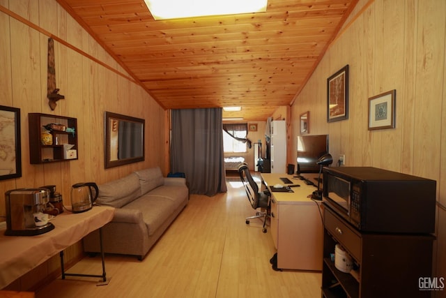 office featuring light wood-type flooring, vaulted ceiling, wooden walls, and wood ceiling