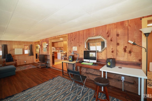 home office with wooden walls and wood-type flooring