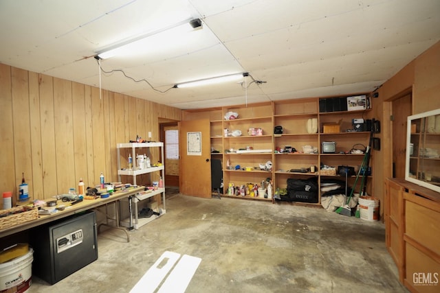 interior space featuring a workshop area and wood walls