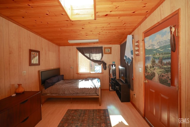 bedroom featuring light hardwood / wood-style floors, wooden walls, and wood ceiling