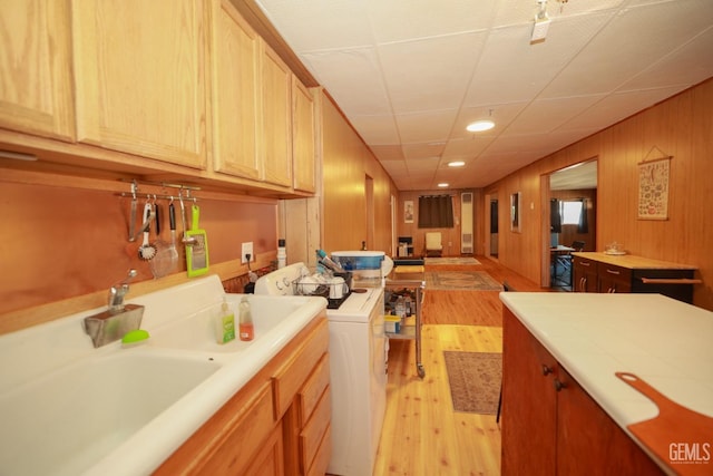 laundry room with light hardwood / wood-style floors and washer / dryer