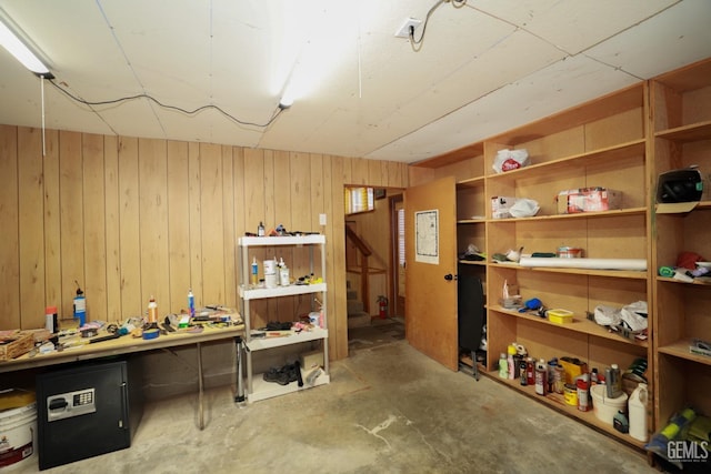 basement featuring wooden walls