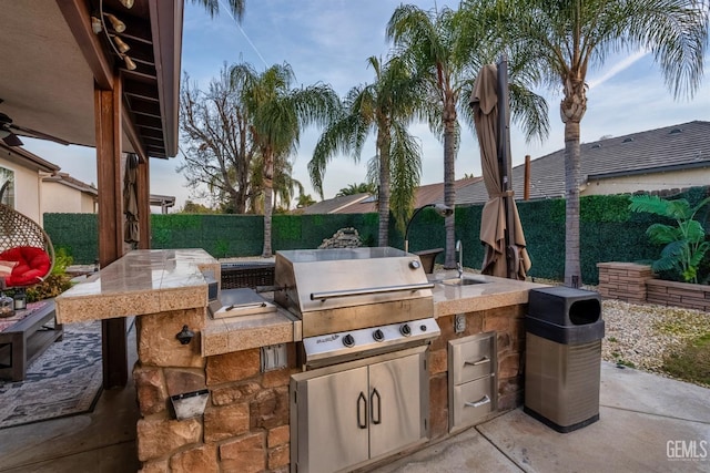 view of patio / terrace featuring exterior kitchen, sink, and grilling area