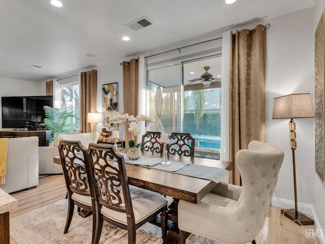 dining space featuring ceiling fan and light wood-type flooring