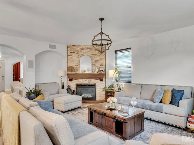 living room with a large fireplace and a chandelier