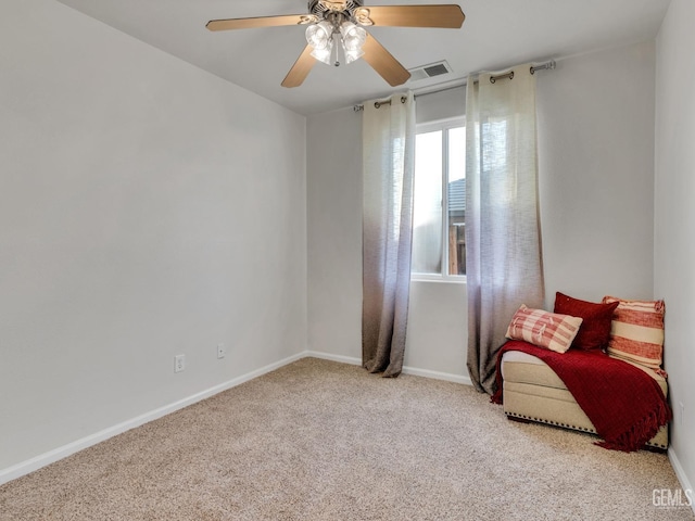 living area featuring light carpet and ceiling fan