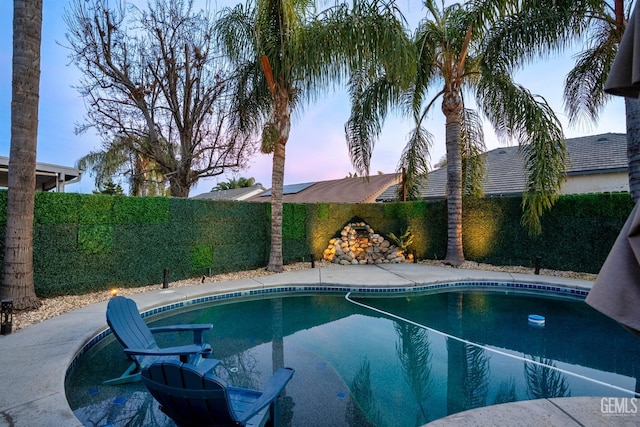 view of pool at dusk