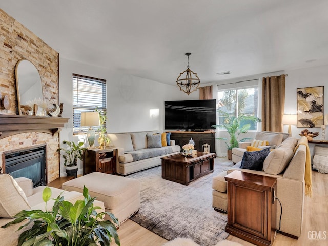 living room featuring an inviting chandelier and light wood-type flooring