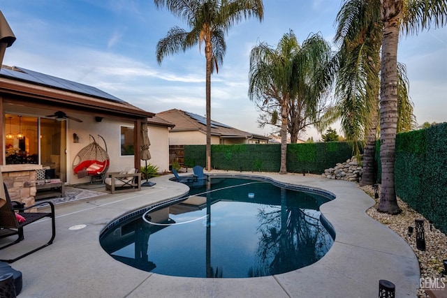 pool at dusk with a patio