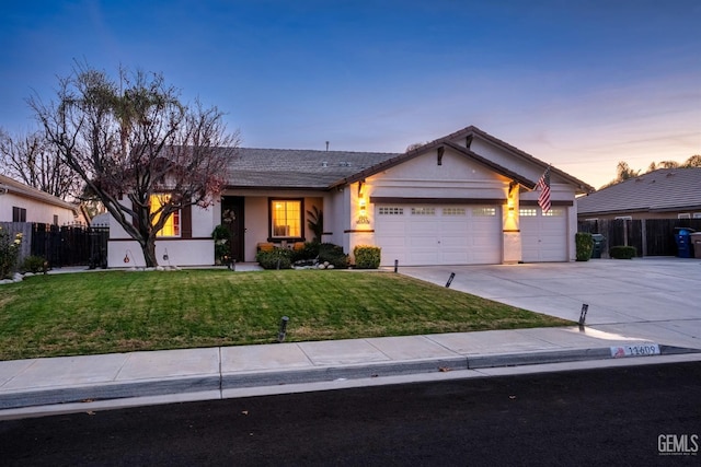 single story home featuring a yard and a garage