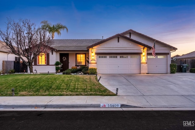 view of front facade featuring a garage and a yard