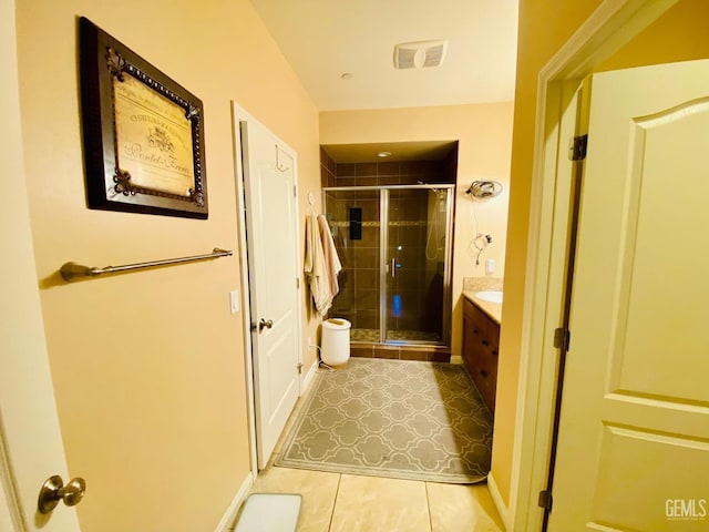 bathroom with tile patterned floors, vanity, and a shower with shower door