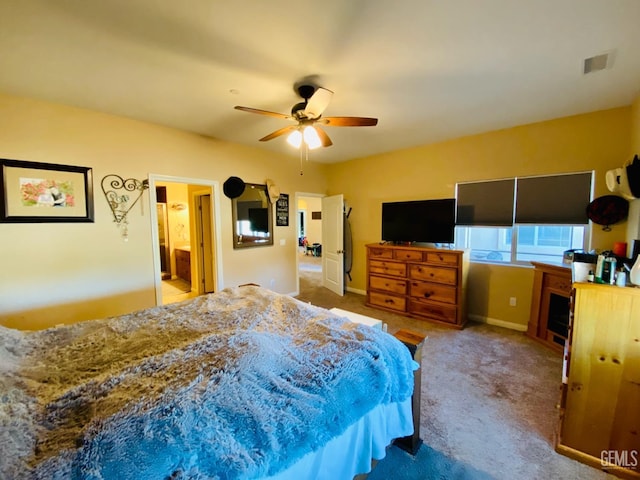 carpeted bedroom with ceiling fan and ensuite bathroom