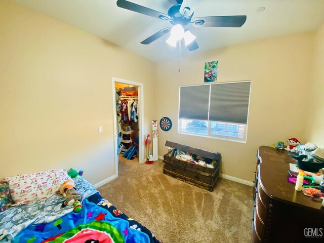 carpeted bedroom featuring ceiling fan and a closet