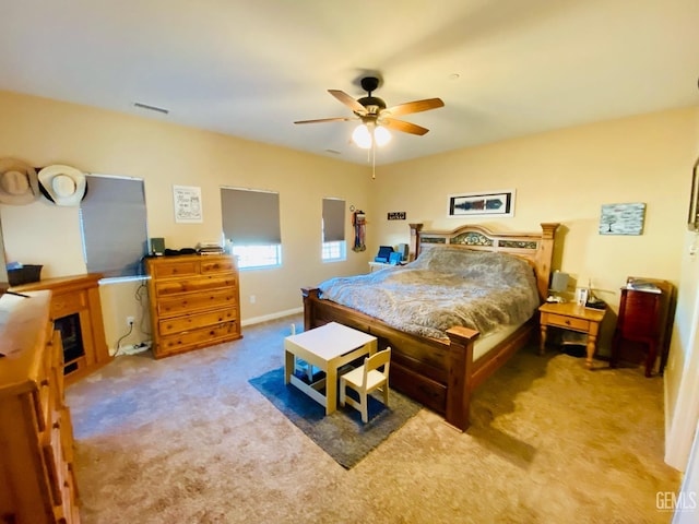 bedroom with ceiling fan and light colored carpet