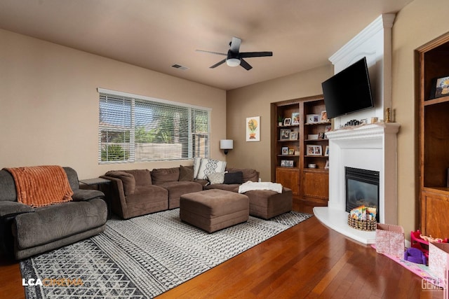 living room with ceiling fan and hardwood / wood-style flooring