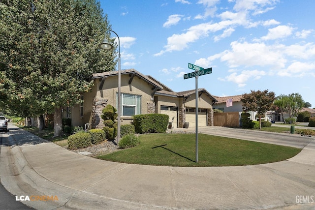 view of front of house featuring a garage and a front lawn