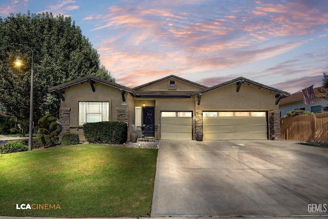 view of front facade with a garage and a yard