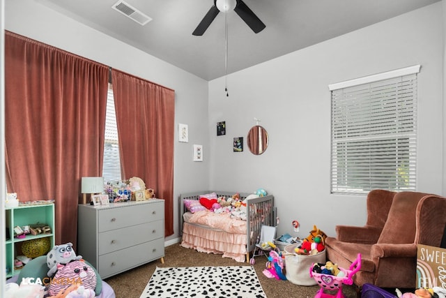 bedroom with dark colored carpet and ceiling fan