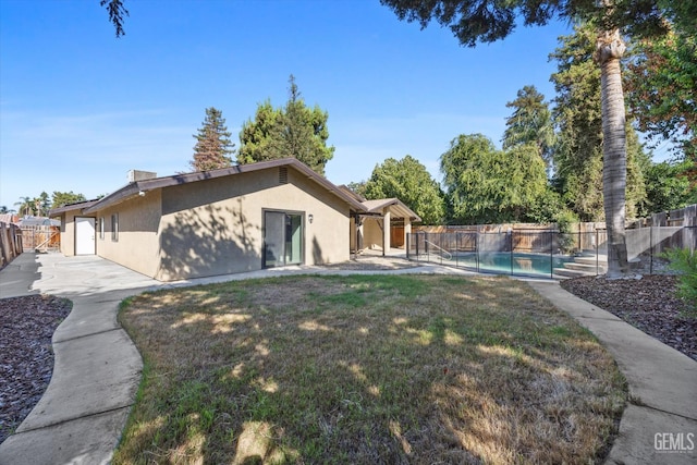 3112 Harrogate Ln, Bakersfield, CA 93309 - back of house featuring a fenced backyard, stucco siding, and a patio area