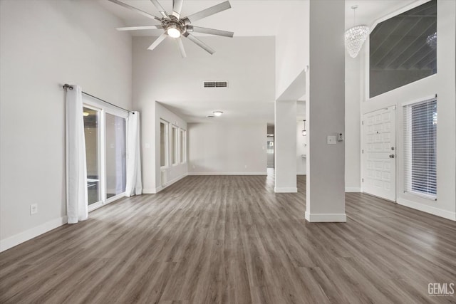 3112 Harrogate Ln, Bakersfield, CA 93309 - unfurnished living room featuring high vaulted ceiling, wood finished floors, a ceiling fan, and a chandelier