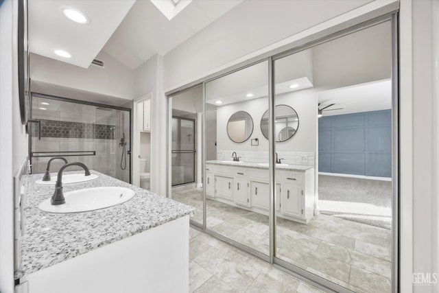 3112 Harrogate Ln, Bakersfield, CA 93309 - bathroom with double vanity, a ceiling fan, and vaulted ceiling