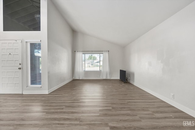 3112 Harrogate Ln, Bakersfield, CA 93309 - unfurnished living room featuring wood finished floors and high vaulted ceiling